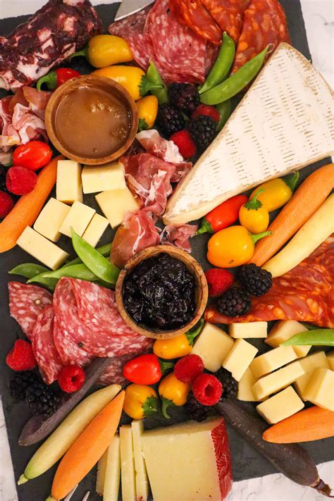 Learn how to make a simple Charcuterie Board, a beautiful assortment of cured meats, cheese, crackers, spreads, fruit and nuts that perfectly complement each other. It will be a great appetizer for just about any occasion. Prep Time 20 mins. Cook Time 0 mins. Total Time 20 mins.